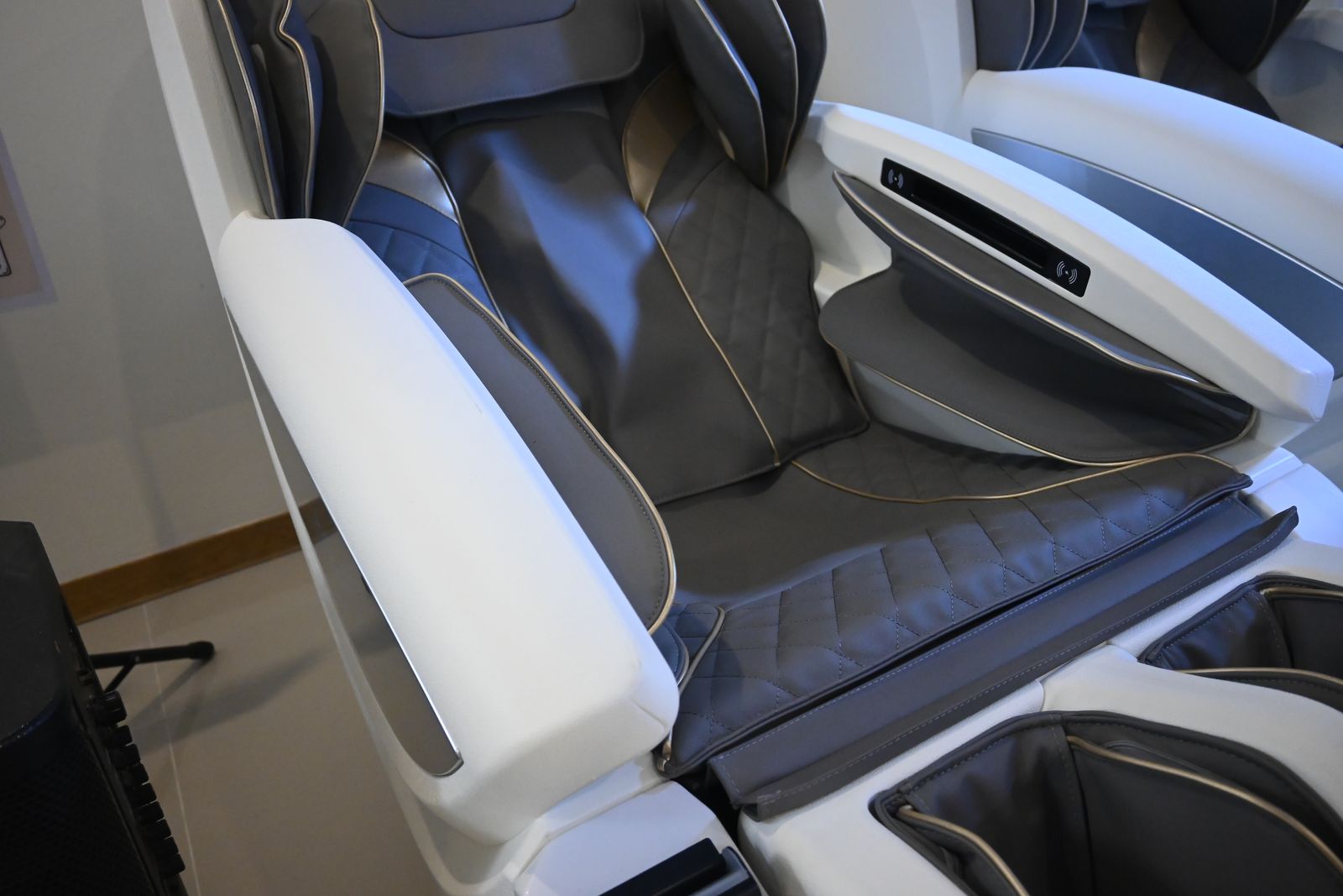 Close-up of a RelaxPod massage chair seat and armrest